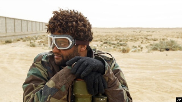 A rebel fighter holds an anti-aircraft rocket launcher in Ajdabiyah, Libya, March 15, 2011