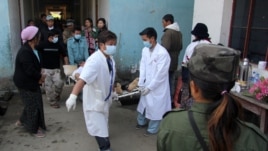 Medical staff at the Laiza hospital carry a man on a stretcher after he was injured during an artillery attack by the Burmese military in the town of Laiza, January 14, 2013. 
