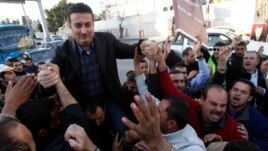 Ahmed Safadi, who won a seat in parliamentary elections, celebrates with his supporters in Amman, Jordan, January 24, 2013.