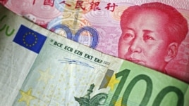 A 100 Euro banknote is placed on top of a 100 yuan banknote in this illustration taken in Beijing, November 7, 2010.