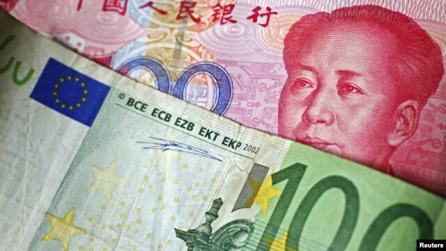 A 100 Euro banknote is placed on top of a 100 yuan banknote in this illustration taken in Beijing, November 7, 2010.
