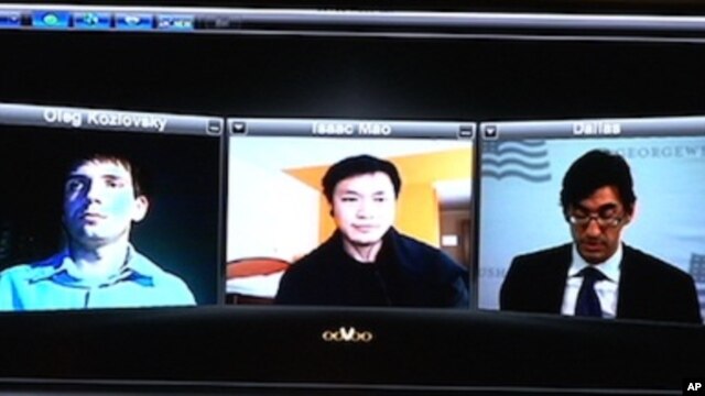 Oleg Kozlovsky, Issac Mao, Ernesto Hernandez Busto use the Skype technology to participate in the recent conference on the Internet and dissidents