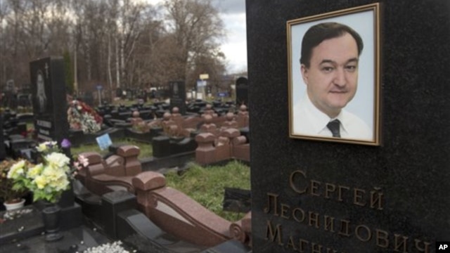 caption: A tombstone on the grave of lawyer Sergei Magnitsky, who died in jail, at a cemetery in Moscow, November 16, 2012.