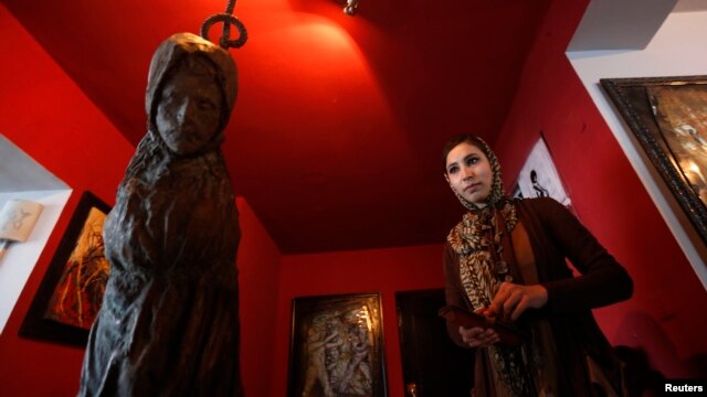 Afghan artist Malina Suliman is pictured inside The Venue art gallery in Kabul December 2, 2012.