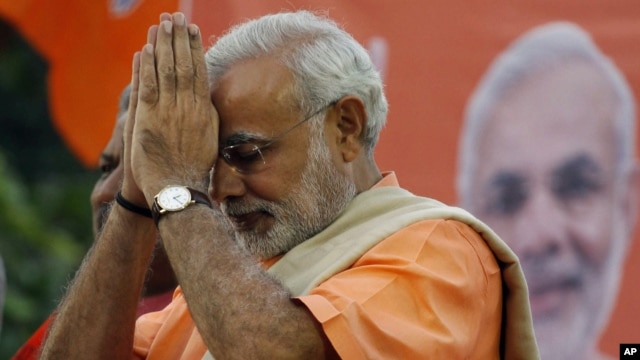 Narendra Modi, chief minister for Gujarat state, greets supporters during the celebrations of Gujarat assembly elections in Ahmadabad, India, Dec. 20, 2012.