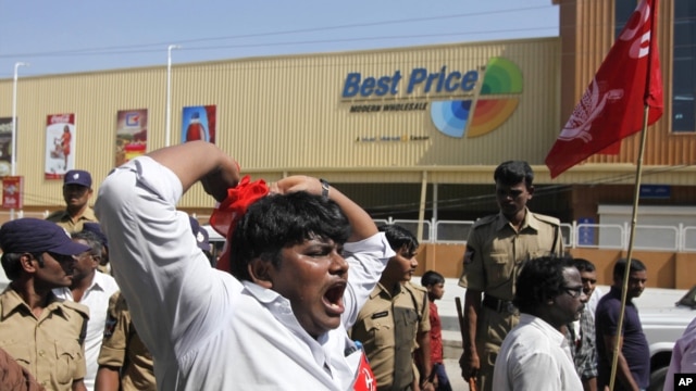 India’s leftist party activists shout slogans during a protest in front of a Bharti Walmart Best Price wholesale store in Hyderabad, India, November 19, 2102.