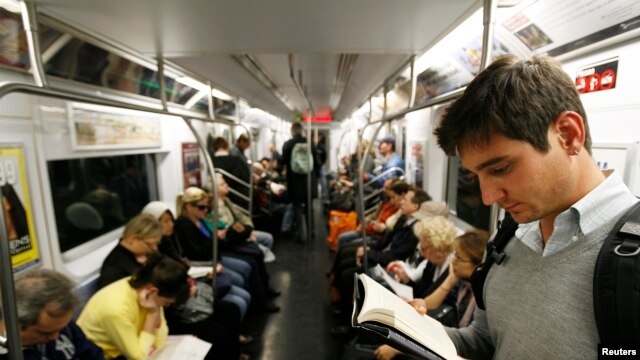 People who take public transportation, like these commuters on the New York City subway, are able to relax, read and avoid traffic. (FILE PHOTO/October 2008)