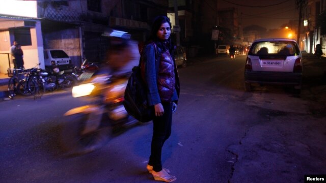 Sheetal, 23, who works at a night call center, poses for a photograph outside her office in New Delhi, January 12, 2013. 