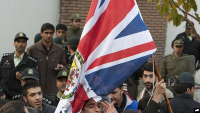 Protesters remove the flag of the British embassy in Tehran, November 29, 2011.