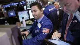 Traders work on the floor at the New York Stock Exchange in New York, January 2, 2013.