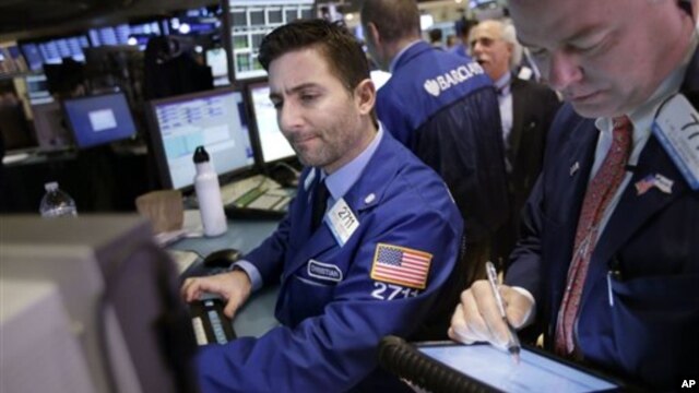Traders work on the floor at the New York Stock Exchange in New York, January 2, 2013.