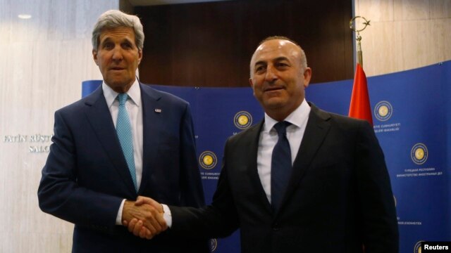 FILE - U.S. Secretary of State John Kerry (L) and Turkey's Foreign Minister Mevlut Cavusoglu pose before a meeting in Ankara, September 12, 2014.  