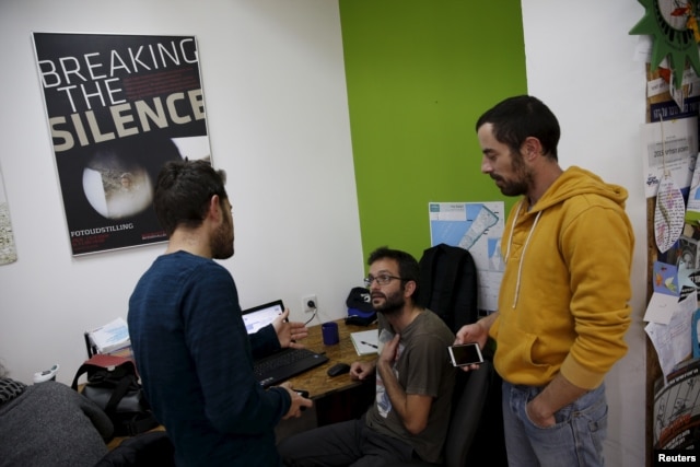 Employees work at the offices of "Breaking the Silence" in Tel Aviv, Israel, December 16, 2015. An ultra-nationalist Israeli group has published a video accusing the heads of four Israel's leading human rights organisations, including "Breaking the Silenc