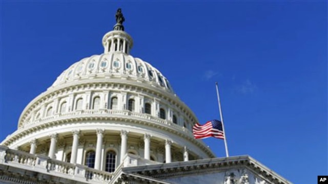 The American flag flies at half-staff on the US Capitol in Washington to honor the slain aide, Gabe Zimmerman, of Rep. Gabrielle Giffords, D-Ariz., 09 Jan 2011.