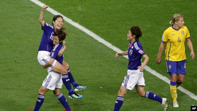 Homare Sawa (L) of Japan celebrates with her teammate Nahomi Kawasumi after scoring against Sweden during their Women's World Cup semi-final soccer match in Frankfurt, July 13, 2011