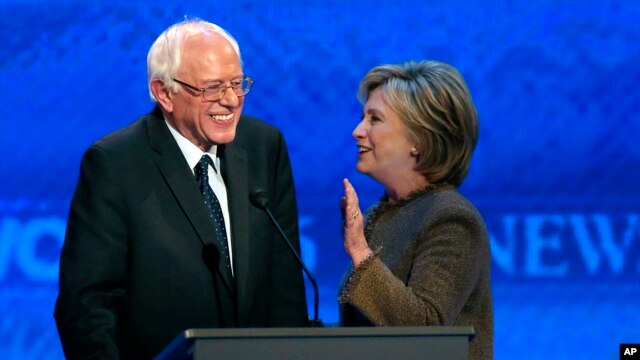 Fie - Hillary Clinton speaks to Bernie Sanders during a break at the Democratic presidential primary debate, Dec. 19, 2015, Manchester, N.H. 