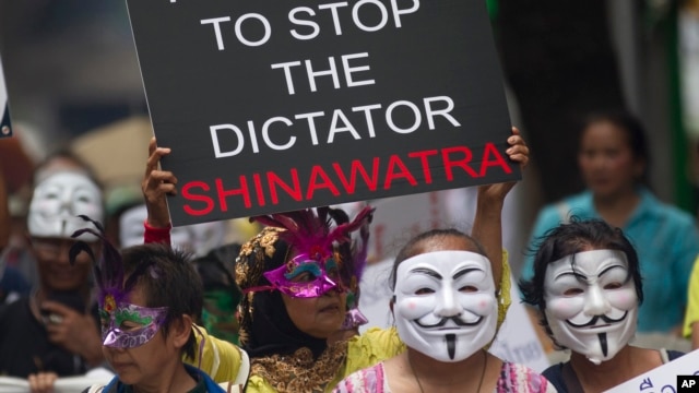 Masked Thai protesters holding placards and banners stage an anti-government rally  in Bangkok, May 31, 2013. 