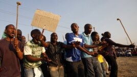 Striking platinum miners are seen gathered at Lonmin's Marikana mine in South Africa August 29, 2012.