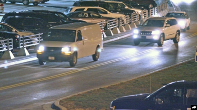 A white van, believed to be transporting Staff Sgt. Robert Bales, leaves Kansas City International Airport Friday, March 16, 2012, in Kansas City, Mo. 