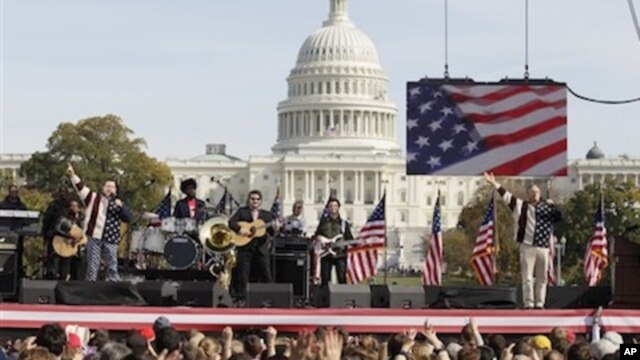 Comedians Jon Stewart, right, and Stephen Colbert, left, perform during their Rally to Restore Sanity and/or Fear on the National Mall in Washington, Saturday, Oct. 30, 2010.