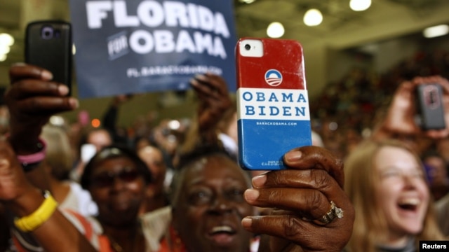 A supporter uses her personalized mobile phone to take a picture of U.S. President Barack Obama as he speaks at a campaign event at the Florida Institute of Technology in Melbourne, Florida, September 9, 2012.