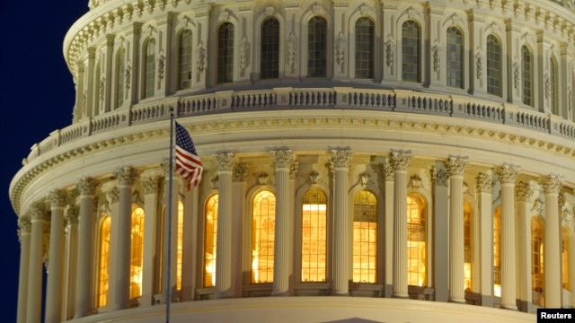 The United States Capitol Dome is seen before dawn in Washington, March 22, 2013.  