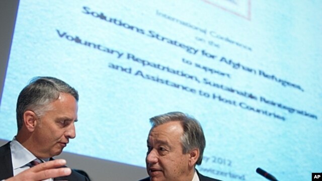 Swiss Foreign Minister Didier Burkhalter (L) gestures next to U.N. High Commissioner Antonio Guterres for refugees at the opening of a two-day International conference on the Afghan refugee situation on May 2, 2012 in Geneva.