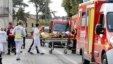 Rescue workers carry a injured person on a stretcher during rescue operations near the site where a coach carrying members of an elderly people's club collided with a truck outside Puisseguin near Bordeaux, western France, October 23, 2015.