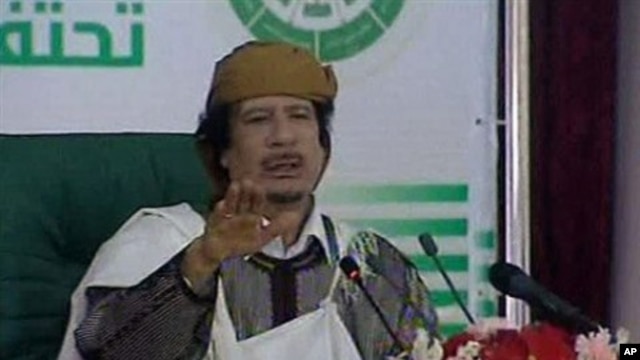 This video image taken from Libyan state television broadcast Wednesday March 2, 2011 shows Libyan leader Moammar Gadhafi addressing supporters and foreign media on Wednesday in a conference hall in the capital Tripoli, Libya