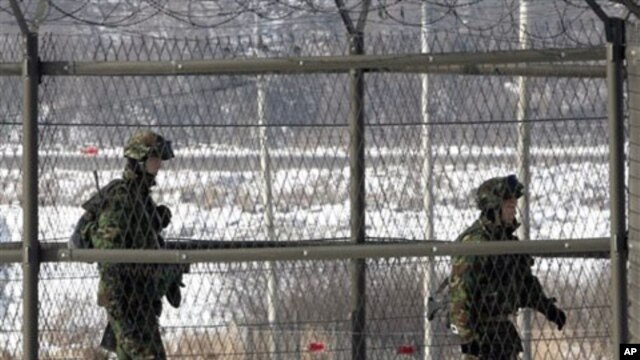 South Korean border guards patrol the fence-line at the Imjingak Pavilion near the border village of Panmunjom in Paju, 01 Jan 2011