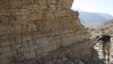 A researcher studies rocks in the United Arab Emirates that were on the seafloor at the time and contained a detailed record of the changing ocean conditions at the end of the Permian Period in this undated handout image released on April 9, 2015.
