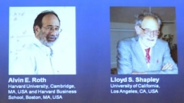 Pictures of U.S. economists Alvin Roth and Lloyd Shapley, who won the 2012 Nobel prize for economics, are seen projected at the Swedish Royal Academy of Sciences in Stockholm, Sweden, October 15, 2012. 