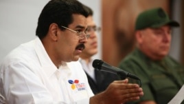 Venezuela's Vice President Nicolas Maduro (L) speaks during a meeting with political and military leader at Miraflores Palace in Caracas, March 5, 2013 in this photo provided by Miraflores Palace.