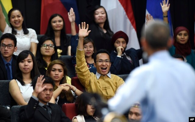 Audience members raise their hands in hopes of asking U.S. President Barack Obama a question as he speaks at the Young Southeast Asian Leaders Initiative (YSEALI) town hall at Taylor's University in Kuala Lumpur, Malaysia, Nov. 20, 2015.