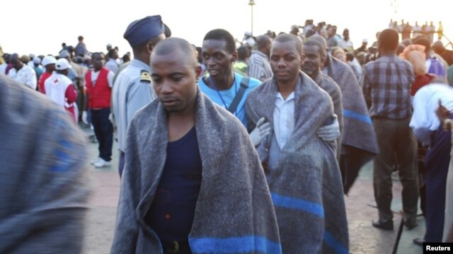 Survivors from a ferry tragedy arrive at the port of Zanzibar, July 18, 2012.