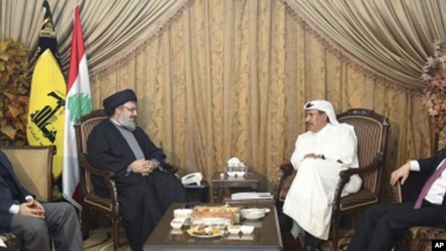 Lebanon's Hezbollah leader Sayyed Hassan speaks with Qatar's Prime Minister and Foreign Minister Sheikh Hamad, as Turkey's Foreign Minister Davutogluat and Hezbollah official al-Khalil listen during their meeting in Beirut, 19 Jan 2011