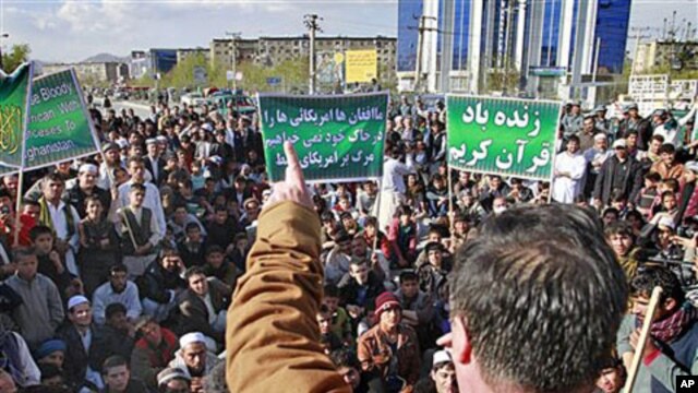 An Afghan protester, Sediq Afghan, talks to demonstrators in Kabul, Afghanistan, after seven United Nations staff members were killed in an attack on a UN compound in northern Afghanistan, April 1, 2011