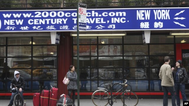 Passengers at a bus station in the Chinatown neighborhood of New York, March 14, 2012.