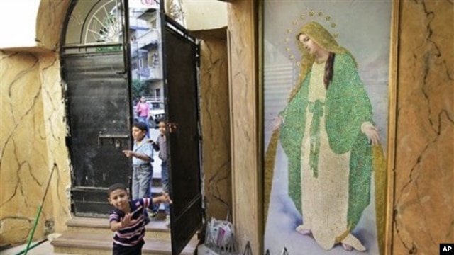 Children run past a painting of Mariam Al-Adra (Virgin Mary) inside the entrance of the Virgin Mary Coptic church in the al-Asafra area of the coastal city of Alexandria, Egypt (July 2010 file photo)