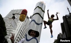 A runner is dressed in a costume depicting the Rio 2016 Olympic torch, decorated with a figure of Jamaica's Usain Bolt and a pill, before the annual "Sao Silvestre Run" (Saint Silvester Road Race), an international race through the streets of Sao Paulo, B