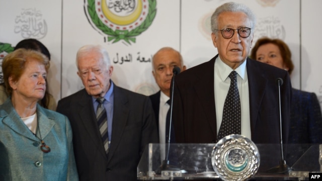 Syria peace envoy Lakhdar Brahimi, behind podium at Arab League headquaraters in Cairo Oct. 24, 2012. Seen in the background from left are former president of Ireland Mary Robinson (R) and former US president Jimmy Carter (2nd L)