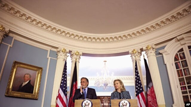 U.S. Secretary of State Hillary Clinton and Afghan Foreign Minister Zalmai Rassoul meet with reporters at the State Department in Washington, March 21, 2012