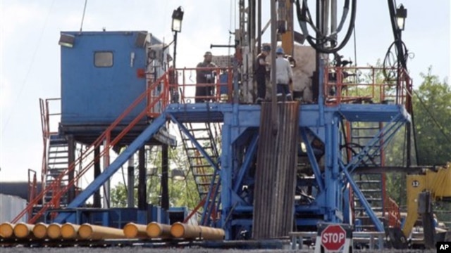 A crew works on a gas-drilling rig at a well site for shale-based natural gas in Zelienople, Pa., June 25, 2012.