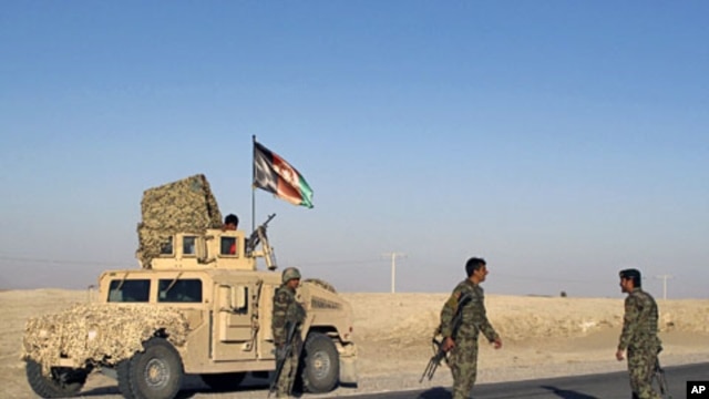 Afghan National Army soldiers arrive near the site of a blast in Helmand province, March 7, 2012