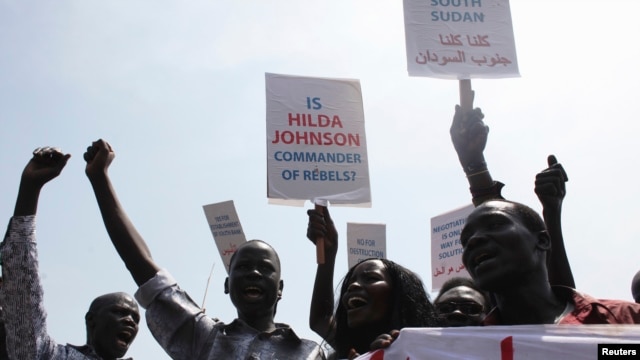 South Sudanese hold banners during a rally in support of President Salva Kiir's administration in Juba, March 10, 2014. 