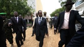 Somalia's new president Hassan Sheikh Mohamud (C) is escorted as he attends his inauguration ceremony in Mogadishu September 16, 2012.