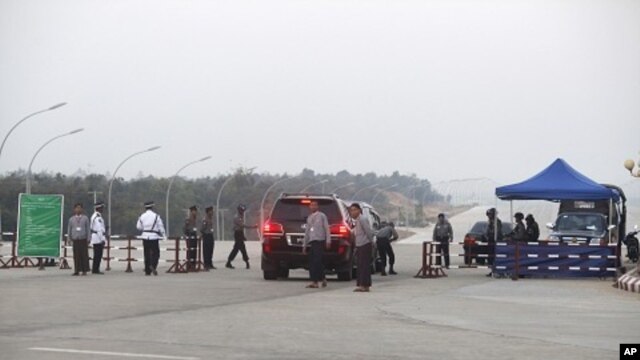A vehicle convoy carrying a lawmaker passes through a checkpoint near the parliament building in Naypyitaw, Jan 30 2011