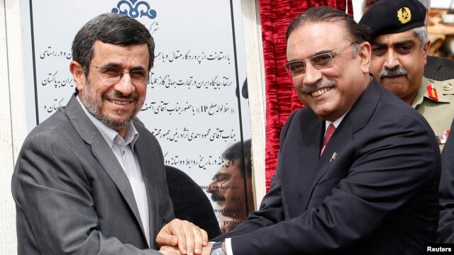 Iran's President Mahmoud Ahmadinejad (L) shakes hands with his Pakistani counterpart Asif Ali Zardari, during a groundbreaking ceremony to mark the start of construction of the Iran-Pakistan gas pipeline, Mar. 11, 2013.