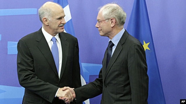 European Council President Herman Van Rompuy, right, welcomes Greek Prime Minister George Papandreou at the European Council building in Brussels, June 20, 2011