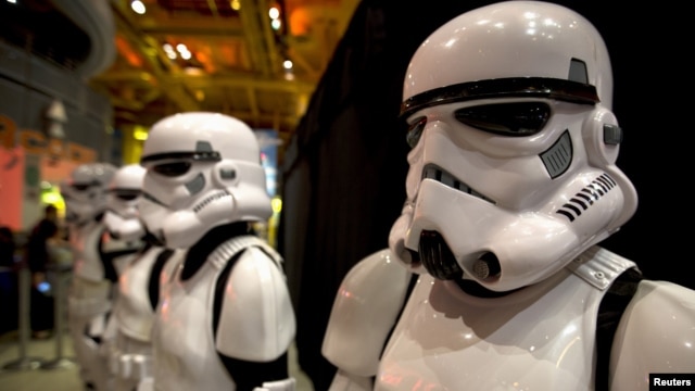 FILE - People dressed as Storm Trooper characters from "Star Wars" await people to purchase toys that are to go on sale at midnight in advance of the film "Star Wars: The Force Awakens" in Times Square in the Manhattan borough of New York.